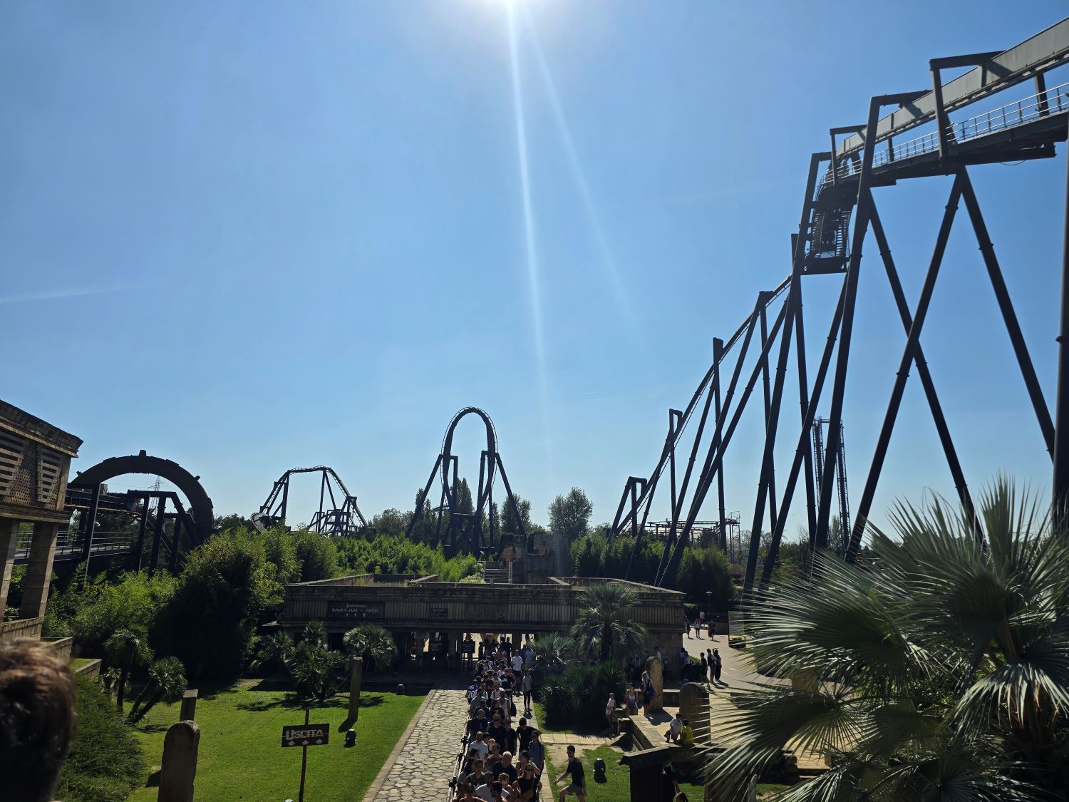 Roller coaster silhouettes against a brilliant blue sky at Mirabilandia